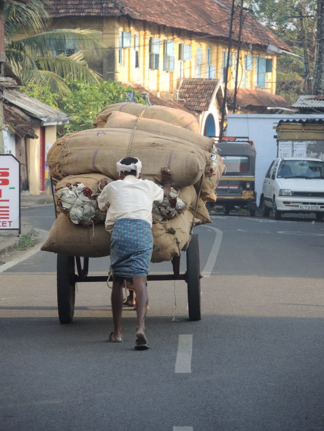 Man pushing cart on Jew Street